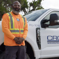 CROM Employee in front of company work truck